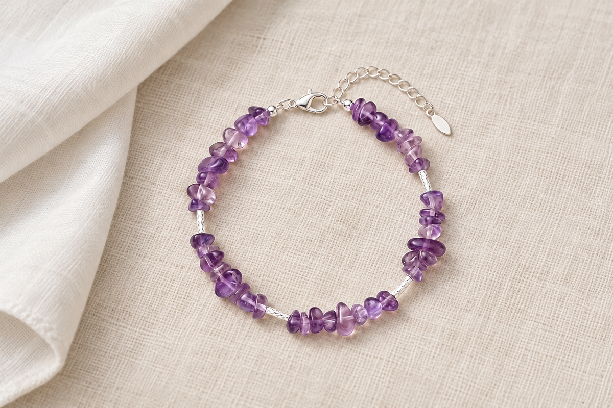 Which hand should a woman wear an amethyst bracelet on for protection, in crystal lore?
