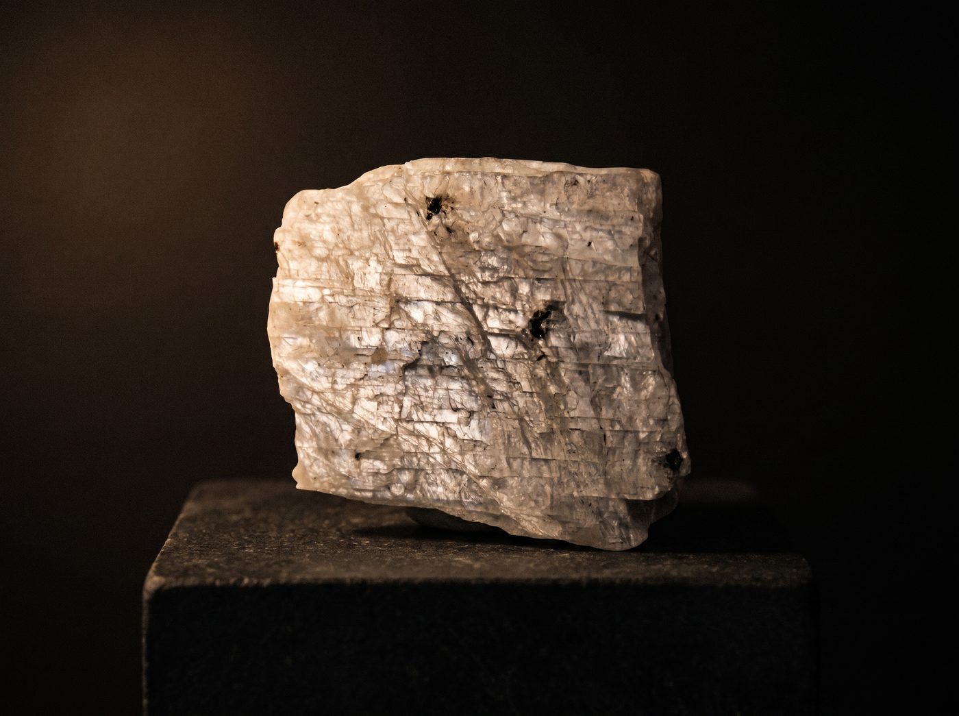 Gray Moonstone rough specimen on dark stone
