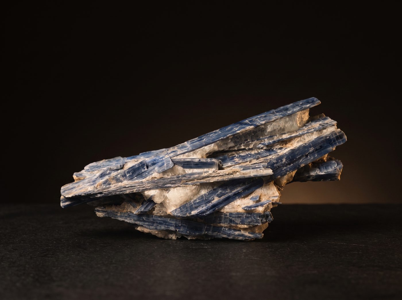 Kyanite rough specimen on dark stone