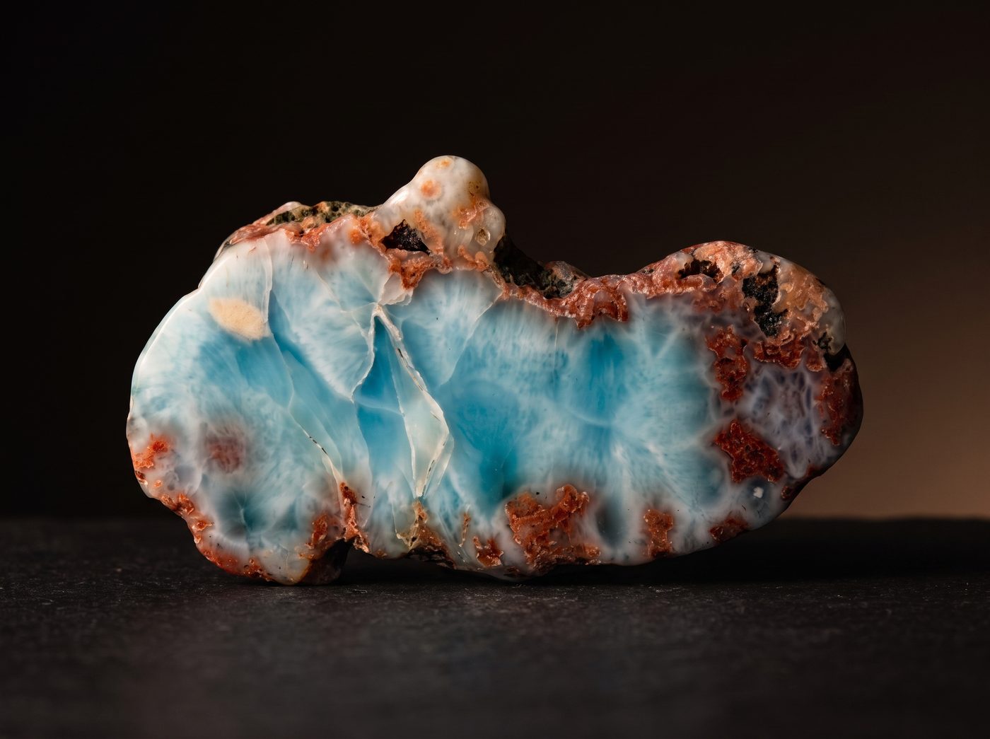 Larimar rough specimen on dark stone