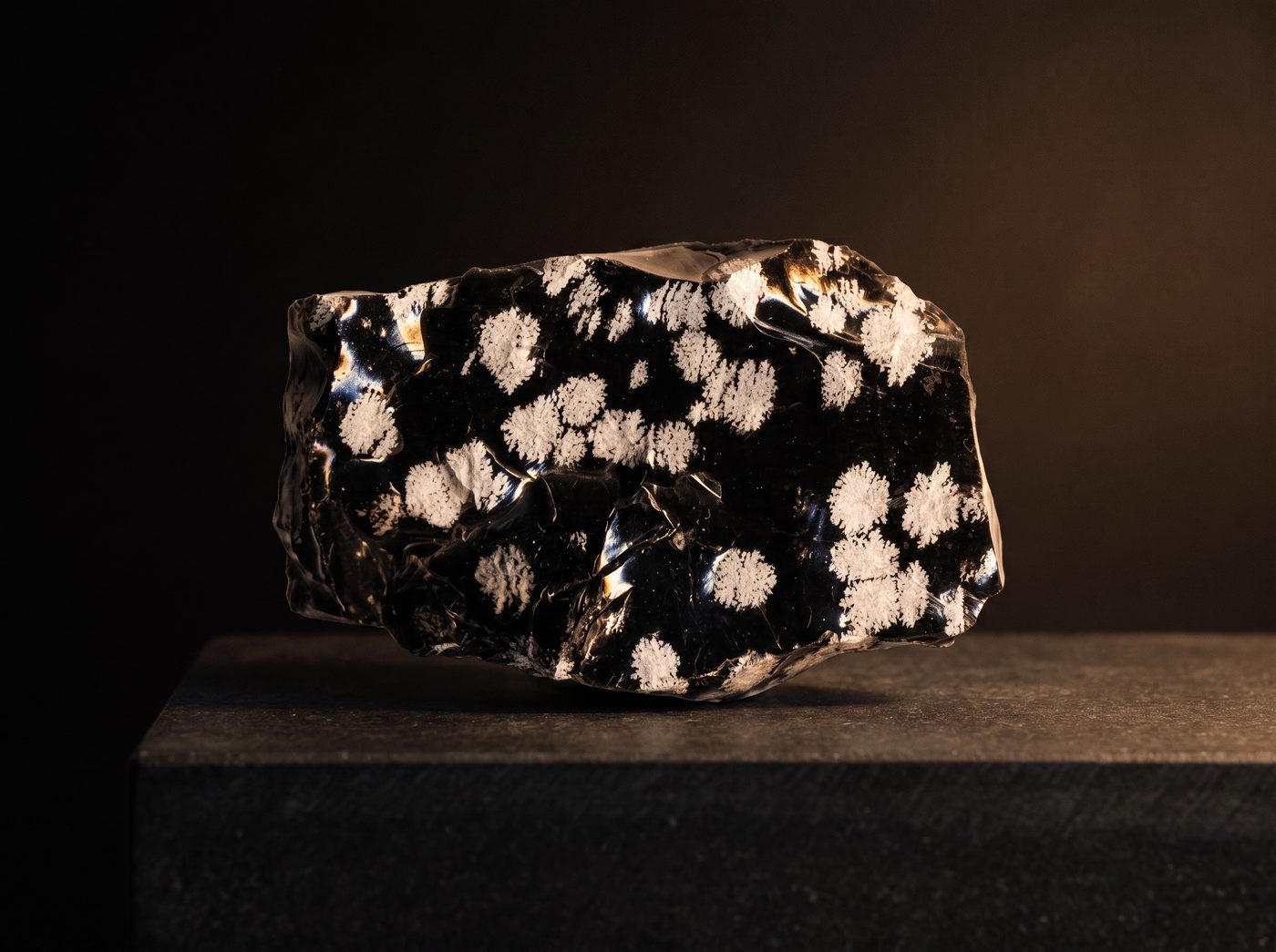 Black Obsidian rough specimen on dark stone