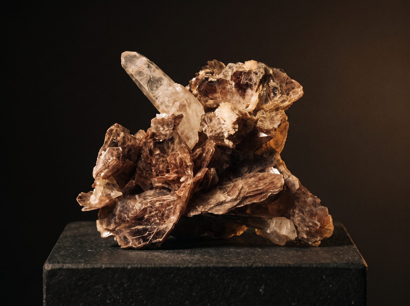Pink Lithium Quartz rough specimen on dark stone