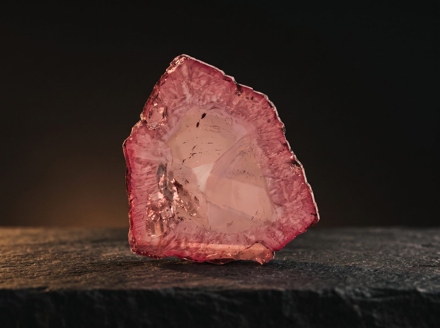 Pink Tourmaline rough specimen on dark stone